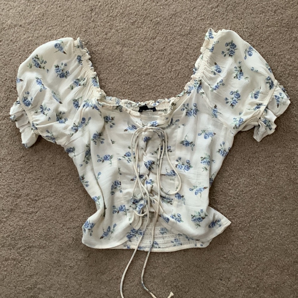 White blouse with blue floral detailing